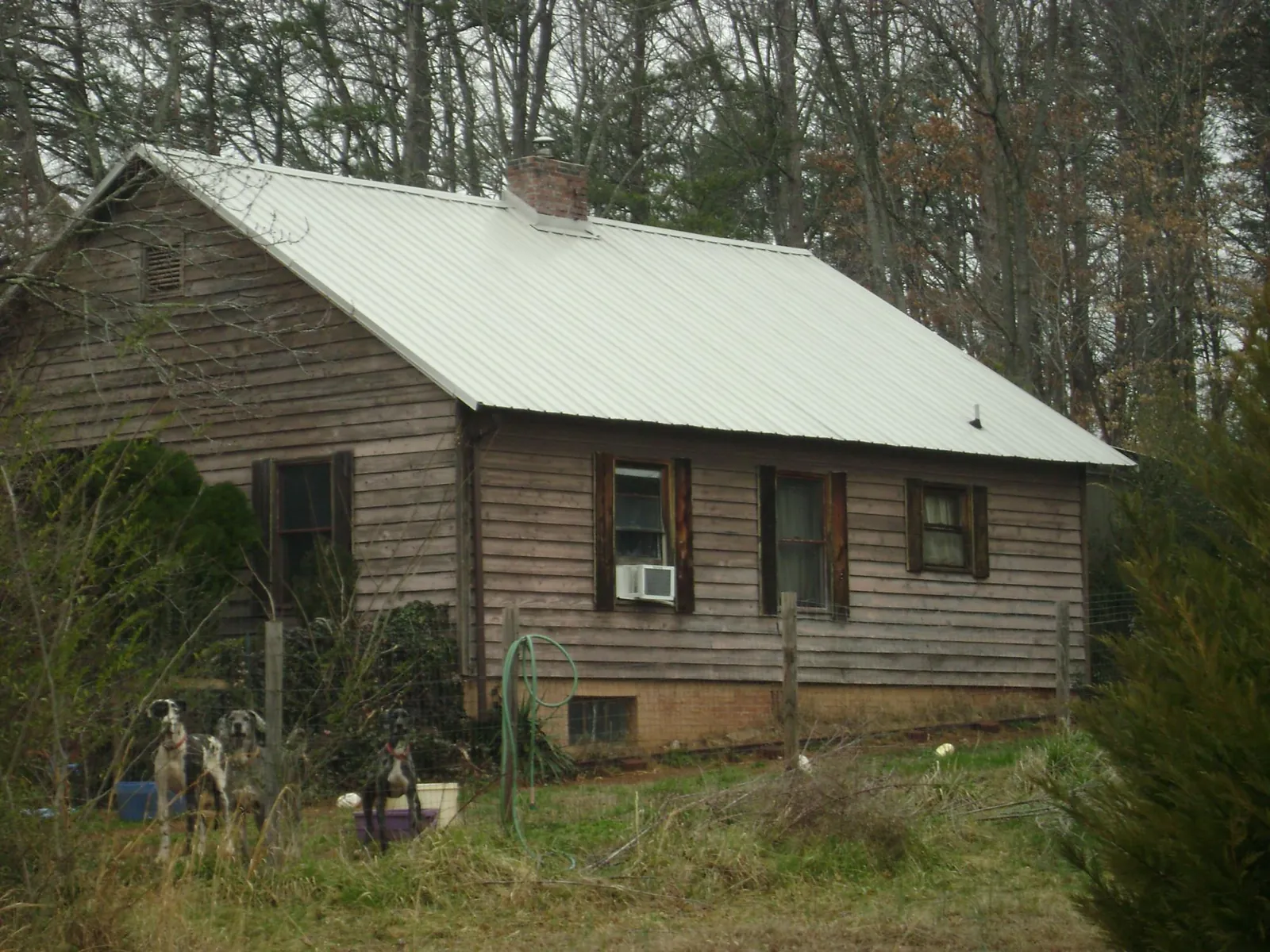 White metal roof on an old wood sided farmhouse, from a Metal Roof Installation job in Dekalb