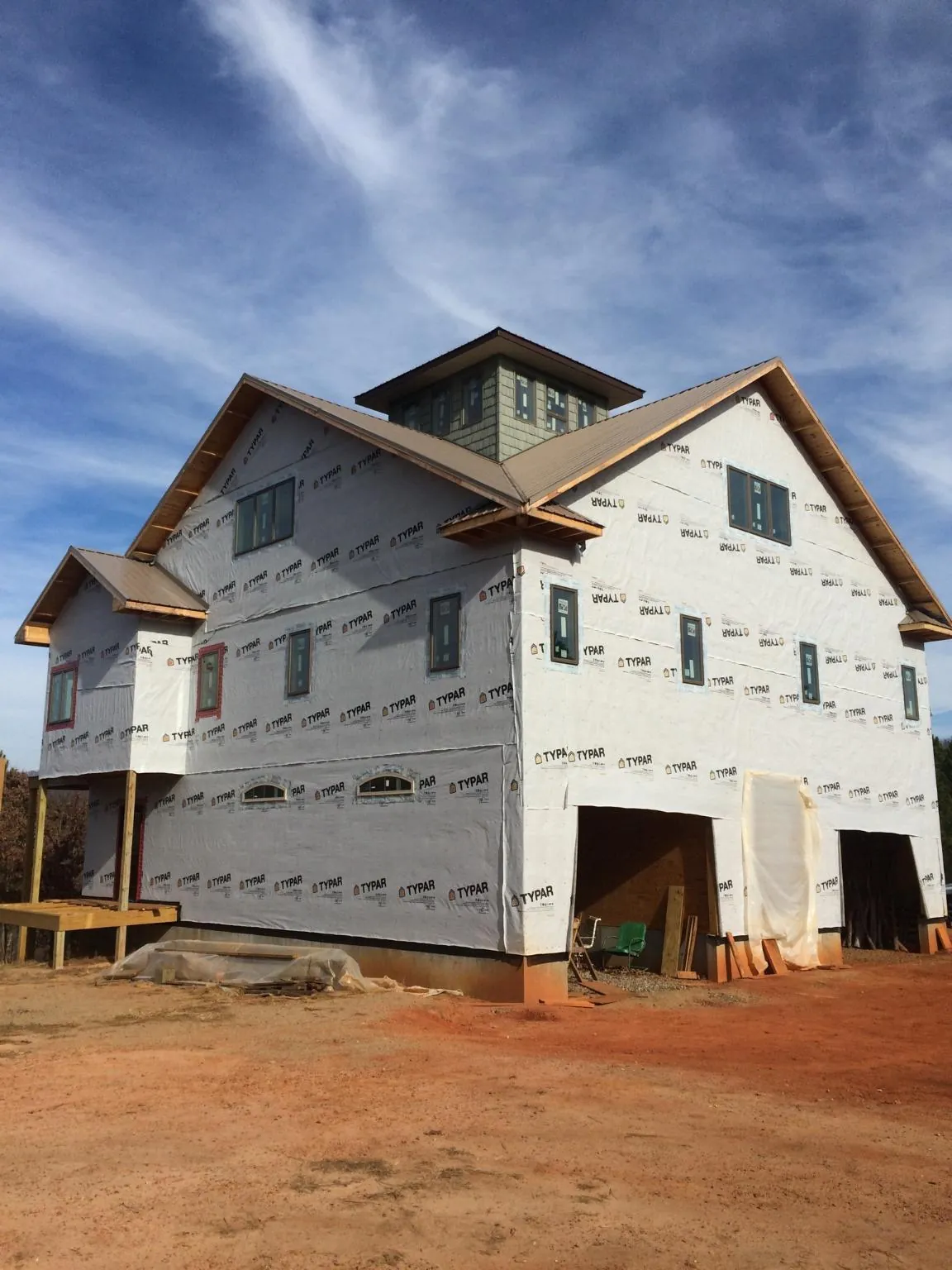 New two story house under construction with a cupola and gabled roofs in Dekalb